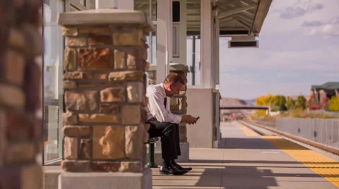 Businessman waiting for train is texting Stock Footage 32242968