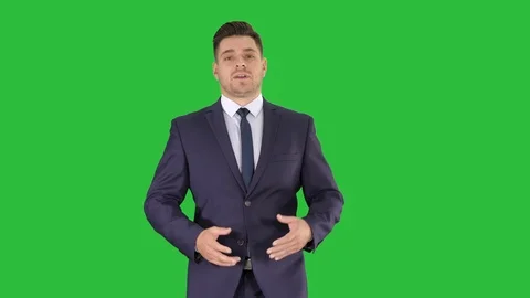 Businessman walking and explaining something to camera on a Green Screen, Chroma Stock Footage 109069078