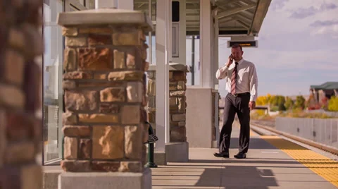 Businessman walking and talking on cell phone Stock Footage 32243030