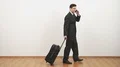 The businessman walking with a bag and phoning on a white wall background 4k or 4k+ Resolution