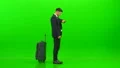 The businessman walking with a bag on the green background 4k or 4k+ Resolution