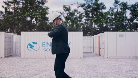 Businessman Walking, Checking Time in Watch with Energy Storage 動画素材 337810993