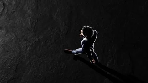 Businessman walking on dark background with dramatic lighting Stock Illustration