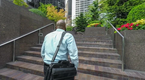Businessman walking up stairs Stock Footage