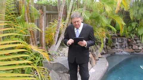 Businessman Walks To Camera By Pool 스톡 동영상 37081642
