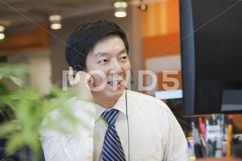 Businessman Wearing Headset in the Office Stock Photos
