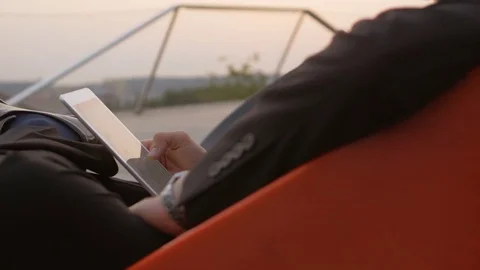 Businessman wearing a suit using a tablet outdoors. Stock Footage 76049130