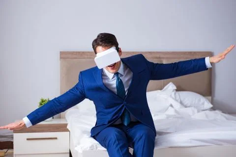 Businessman wearing a virtual reality headset in the bedroom Stock Photos