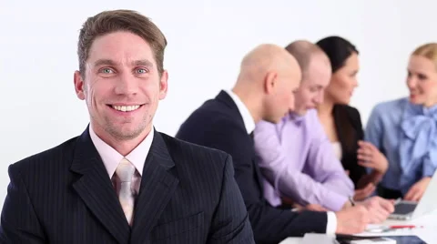 Businessman welcoming smiles on the background of his team Stock Footage 59791593