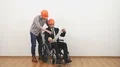 The businessman on the wheelchair and a engineer dicuss with a drawing 4k or 4k+ Resolution
