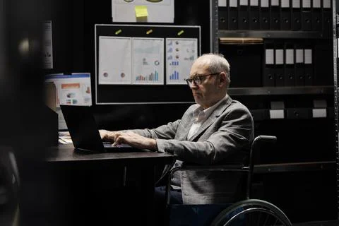 Businessman in wheelchair imputing data Stock Photos