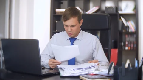 Businessman who scans documents, does not perform an urgent task in the office Stock Footage 88099747