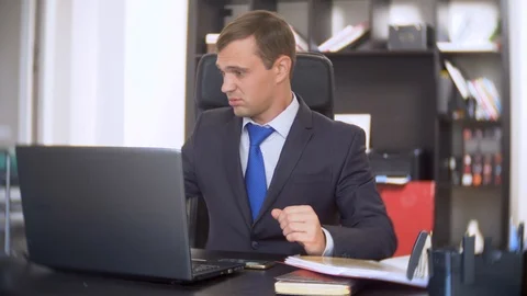Businessman who scans documents, does not perform an urgent task in the office Stock Footage 88100497