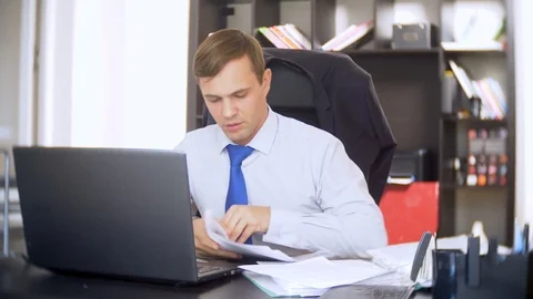 Businessman who scans documents, , does not perform an urgent task in the office Stock Footage 88100964