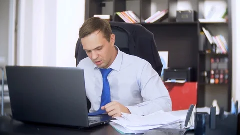 Businessman who scans documents, , does not perform an urgent task in the office Stock Footage 88101119