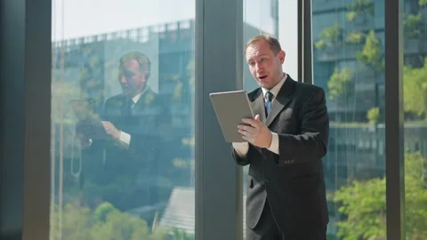 Businessman at the Window Video stock 331059764