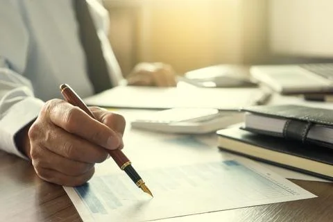 Businessman work with computer on table in office work with paper graph chart 写真素材