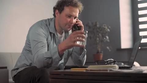 Businessman work on computer touch pad while talking on smart phone. Stock Footage 136332050