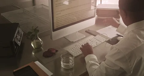 Businessman on work. Puts on glasses, makes notes on paper, drinks water and 動画素材 76551369