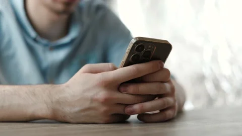 Businessman at work sitting on a table using smartphone Stock Footage 202276406