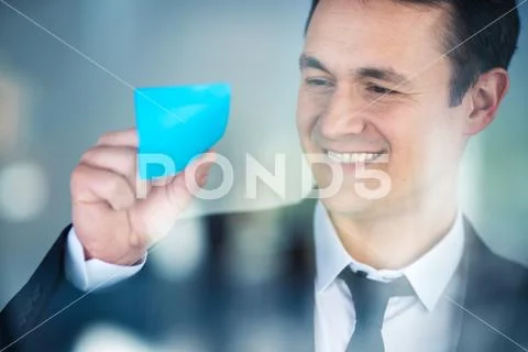 The businessman work with a sticker on the glass Stock Photos