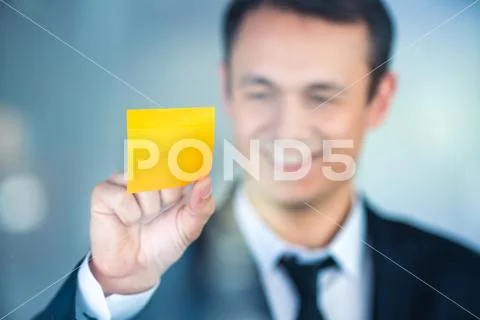 The businessman work with a sticker on the window Stock Photos