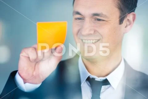 The businessman work with a sticker on the window Stock Photos