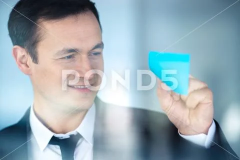The businessman work with a sticker on the window Stock Photos