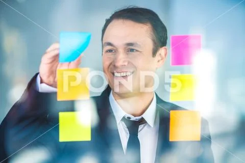The businessman work with stickers on the glass Stock Photos