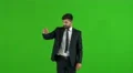 The businessman work with the virtual screen on the green background. Real time 4k or 4k+ Resolution