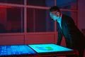 The businessman working with big displays in the dark room Photo