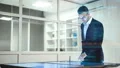 The businessman working with a big screen on the hologram background 4k or 4k+ Resolution