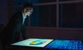 The businessman working with big screens in the dark room Photo