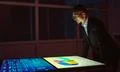 The businessman working with big screens in the dark room Photo