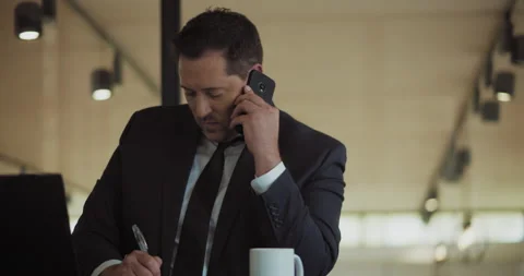 A businessman working on a computer and signing some documents Stock Footage 140201786