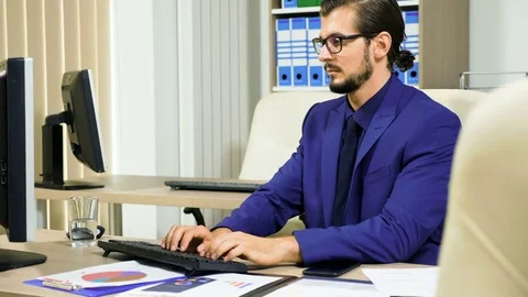 Businessman working on the computer and talking on the phone Stock-Footage 83763497