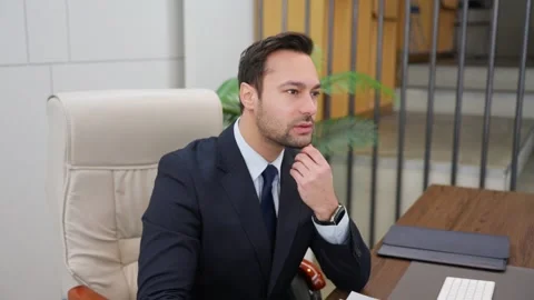 Businessman working with computer, holding paper documents, reading reports Stock Footage 304097778