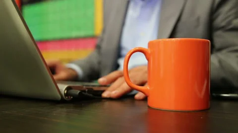 Businessman is working with computer in a office. focus on mug. Stock Footage 37182443