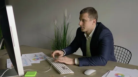 Businessman working at the computer in the office, man shows  gesture okay 스톡 동영상 110943555