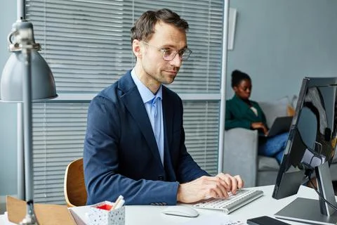 Businessman working on computer at office Stock Photos