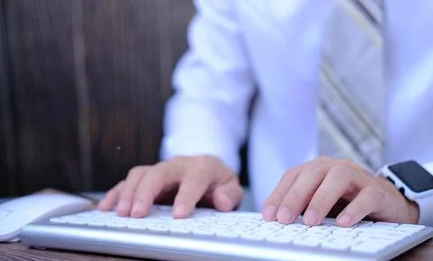 Businessman working on computer in office typing keyboard Stock Photos