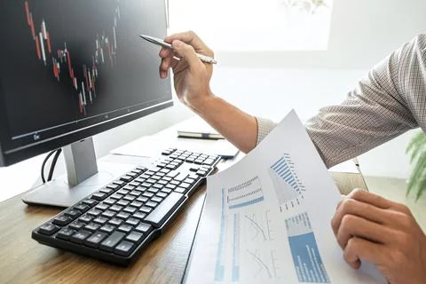 Businessman working with computer, thinking and analyzing graph stock marke.. Stock Photos