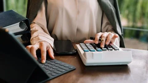Businessman working on desk office with using a calculator to calculate the.. Stock Photos