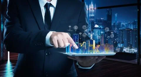 Businessman working on digital table with intelligence iot and smart city sho Stock Photos