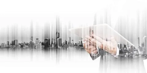 Businessman working on digital tablet with double exposure city Stock Photos
