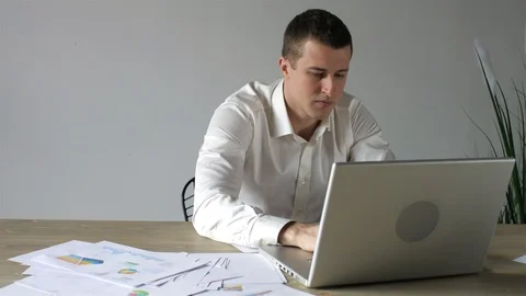 Businessman working with documents and laptop behind workplace 스톡 동영상 107942223