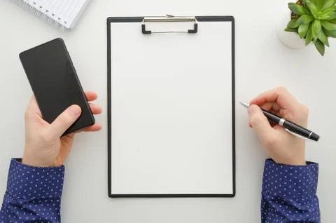 Businessman working with documents and using a mobile phone . Clipboard mockup Stock Photos