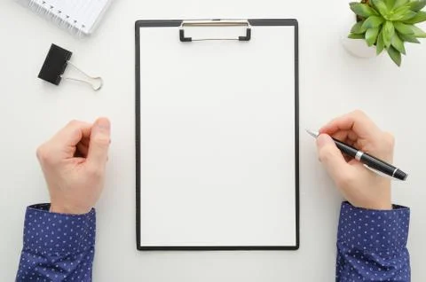 Businessman working with documents and using a mobile phone . Clipboard mockup Stock Photos