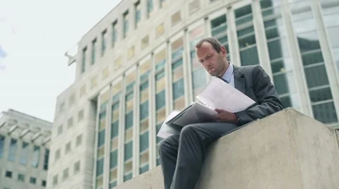 Businessman working with documents in the city HD Stock Footage 11498080