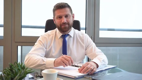 Businessman working, documents looking at camera in office, portrait, dolly shot Vídeo Stock 72500577